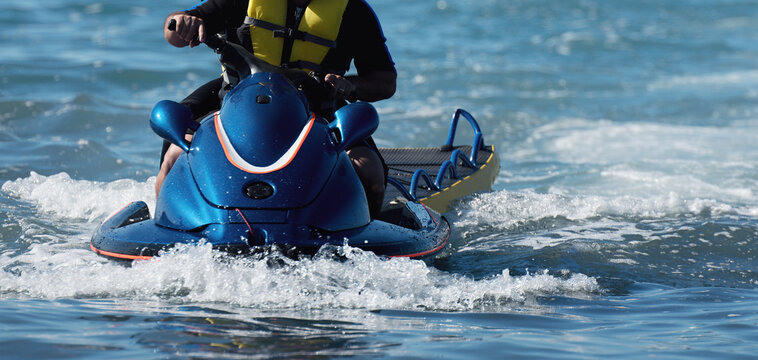 Lifeguard on a jet ski patrols the beach an ocean safety lifeguard riding a jet ski	