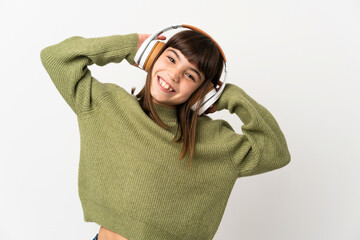 Little girl listening music with a mobile isolated on white background listening music