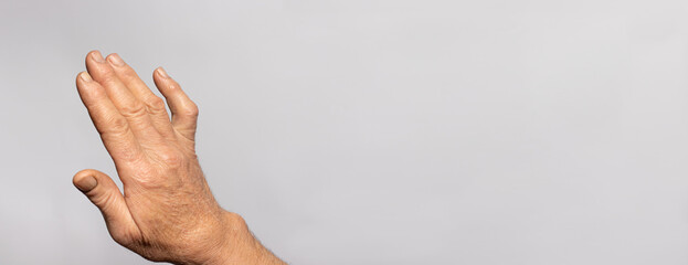 A human hand brush on a gray background with place for text for medicine and traumatology....