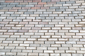 Background, texture. Gray cobblestone pavement after rain.