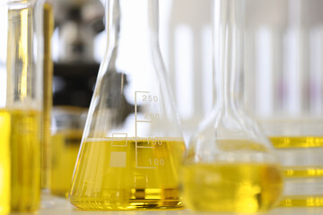 In laboratory, test tubes with yellow liquid are on table. Chemical composition of matter concept