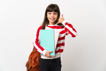 Little student girl isolated on white background making phone gesture. Call me back sign