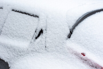 Winter problems of car drivers. Close-up of the top of a car covered with snow on a cold winter day