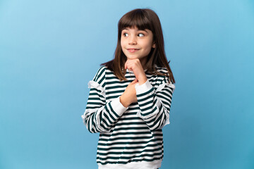 Little girl over isolated background having doubts and thinking