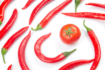 Red hot chili peppers and tomato over white background. Vitamin vegetable food