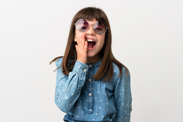 Little girl with sunglasses isolated on white background shouting with mouth wide open
