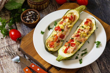 Healthy food. Baked zucchini stuffed with meat and tomatoes on rustic wooden table.