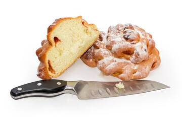 Whole and half of bun with jam, knife, selective focus