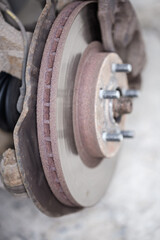 Ventilated  brake disc on used car, closeup in selective focus