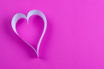 paper ribbon heart on pink background