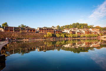Fototapeta na wymiar the river, the boat, stone bridge and the old houses at ancient phoenix town in the morning at Hunan, China. 