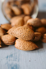 Almonds in a jar on wooden rustic table as background. Close up view.	