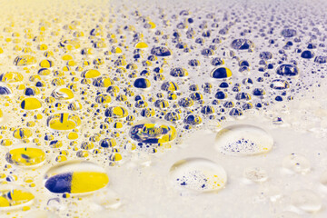 Water drops texture background. Water drops. Yellow and blue.Selective focus.