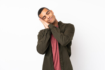 Young African American man over isolated white background making sleep gesture in dorable expression