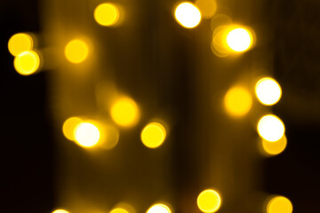 Defocused garland lights, Bokeh effect. Sparkling and fairy background. Christmas and New Year holidays concept.