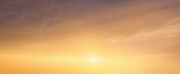 background of cloudscape at the sunset with sunshine on bright sky and orange clouds