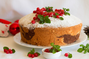 christmas chiffon cake with chocolate, powdered sugar, currant and mint
