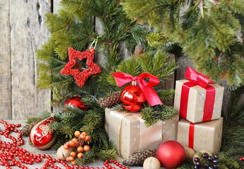 Fototapeta na wymiar Christmas gift background.Christmas toys with boxes of gifts and spruce branches on a wooden background.