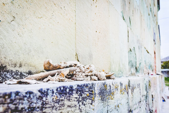 Small peaces of old bones remains on the side of old building wall shelf in open air around Bolnisi zion cathedral. Georgia. Saint places and histrical heritage and sacrilegious acts.