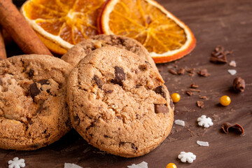 Organic food snack tasty sweet dessert milk dark chocolate chip salt cookie closeup piece fruit orange raspberry hazelnut nuts cinnamon on cocoa cacao powder wooden table for new year Christmas gift