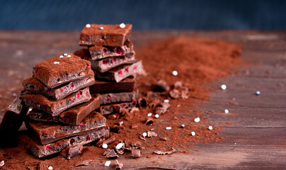 Organic food snack tasty sweet dessert milk dark chocolate bar macro closeup broken slide piece and...