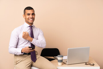 Young business man in a office celebrating a victory