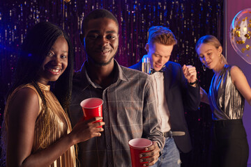 Portrait of young African-American couple smiling at camera while enjoying prom night, copy space © Seventyfour