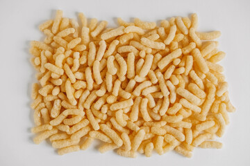 Corn sticks scattered on a white background. Top view. Place for your text