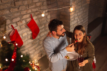 Couple eating and drinking at New Year's Eve party