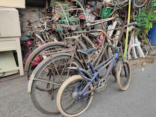 Stack of old bikes on the side of the road