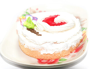 Obraz na płótnie Canvas chiffon cake with jelly topped with whipped cream on a white background, fresh and fresh in a bakery that is ready to serve every festival around the world