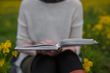 girl reading a book in nature