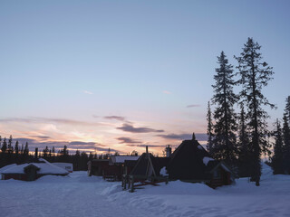 Pastel colored sunset in a small Lapland village with snow covered houses