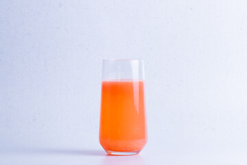 Healthy grapefruit juice in a glass isolated on a white background close up.