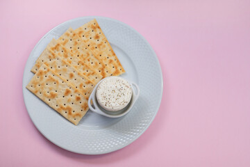 fresh cheese with pepper in small bowl with toasts