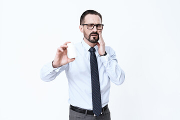 Man holds pills and hold on to bad tooth.