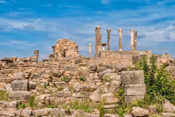 Fototapeta na wymiar The partially restored ruins of the Basilica and Capitoline Temple in the ancient Roman city of Volubilis, near Meknes, Morocco.