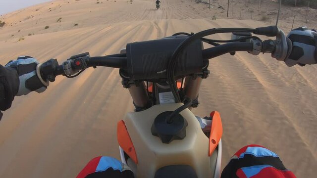 Point of view riding dirt bike in the desert