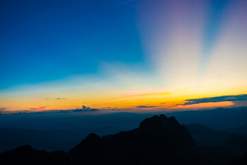 Top of mountain silhouette sunset with colorful sky cloud