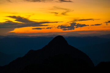 Top of mountain silhouette sunset with colorful sky cloud