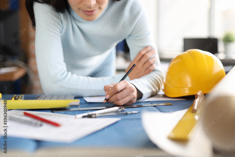 Wall mural designer builder hands draw drawing on table.