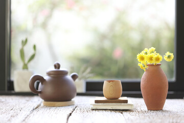 Oriantal clay teapot with cup and pot of flower yellow Chrysanthemum
