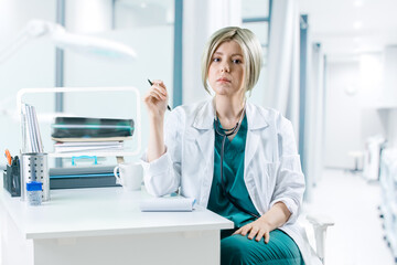 Female doctor sitting at desk at hospital