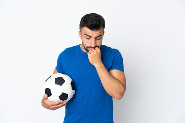 Handsome young football player man over isolated wall having doubts