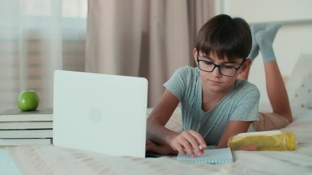 Home Isolation, Online Learning, Remote Work, New Education. A child uses a laptop during online learning