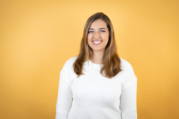 Young caucasian woman over isolated yellow background with a happy face standing and smiling with a confident smile showing teeth