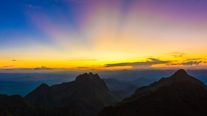 Top of mountain silhouette sunset with colorful sky cloud