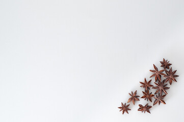 star anise brown with asterisks on a white flat background is located in the corner below. spices for mulled wine