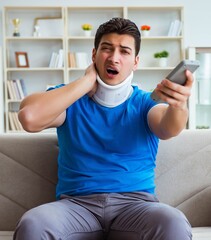 Man with neck injury watching football soccer at home