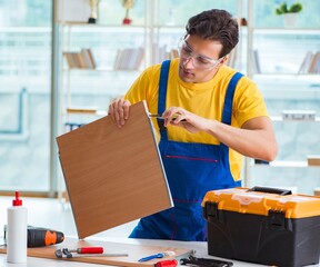 Furniture carpenter working in the workshop